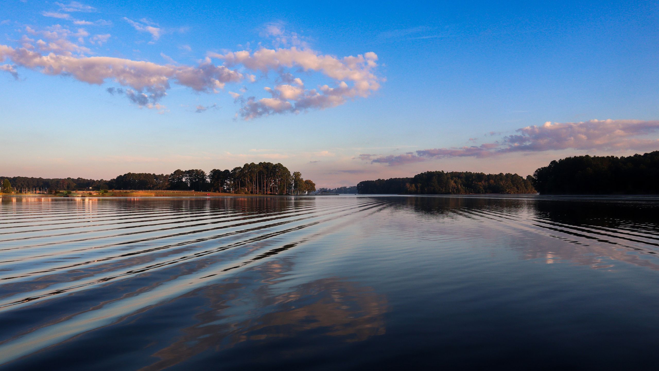 Clouds are relfected on the blue, rippled surface of Lake Sinclair
