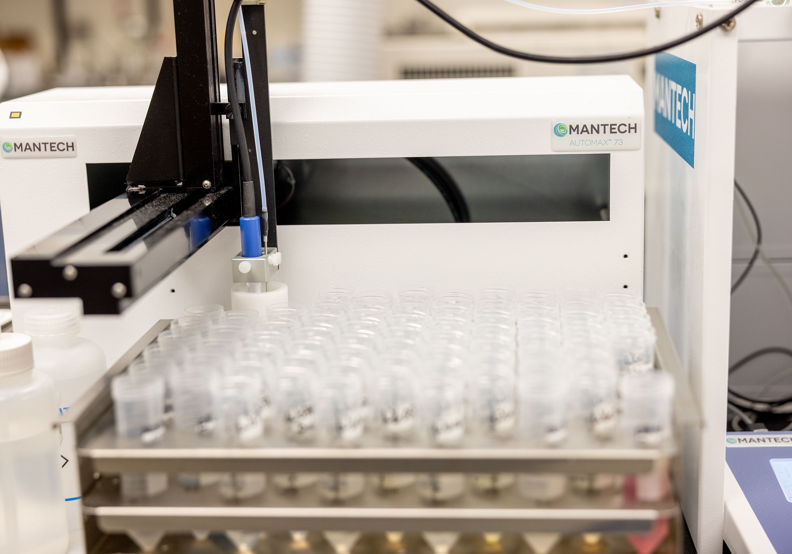 An automated water analysis system performs robotic sampling on a tray of water vials