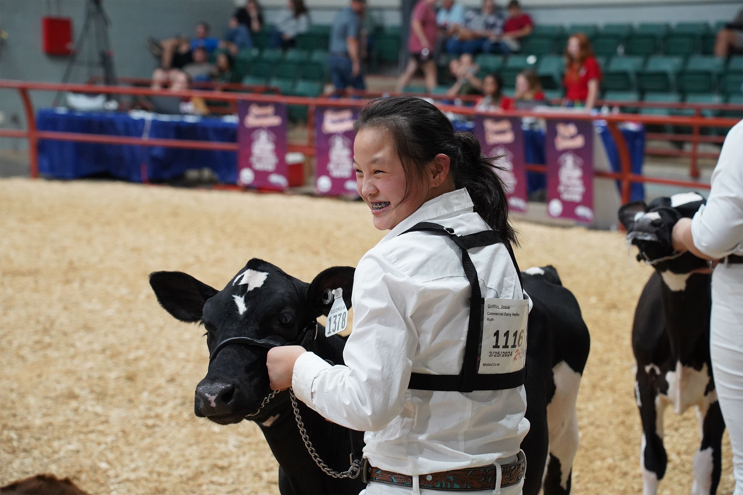 A 4-H participants smiles as she shows her black show cow at the Georgia National Fair. 