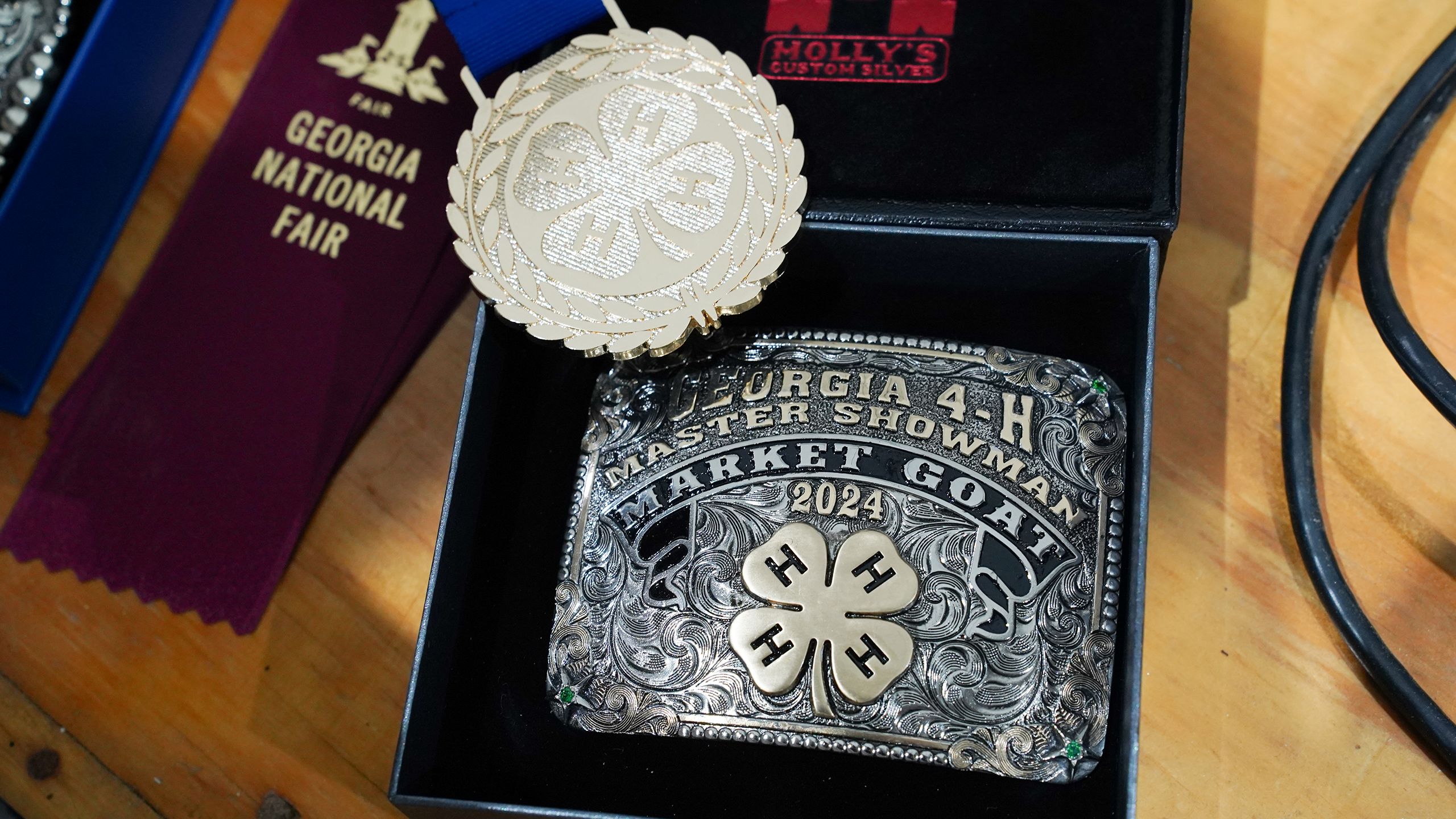 Master showmanship award belt buckle emblazoned with the 4-H clover and Georgia Master Showman Market Goat 2024.