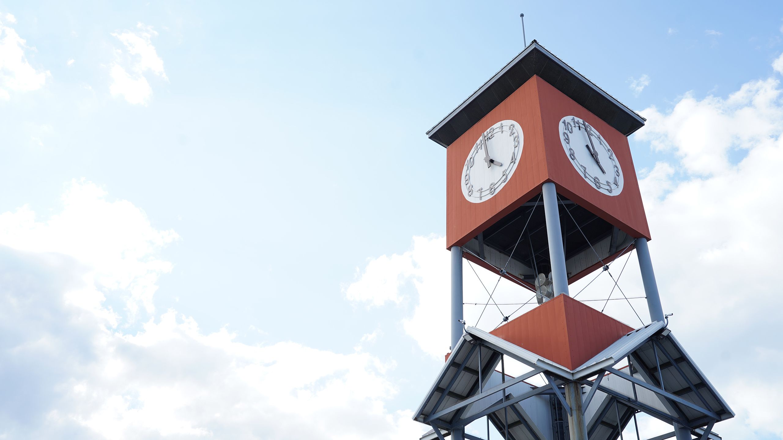 The red and gray clocktower at the Georgia National Fairgrounds in Perry, Georgia, against a blue sky.