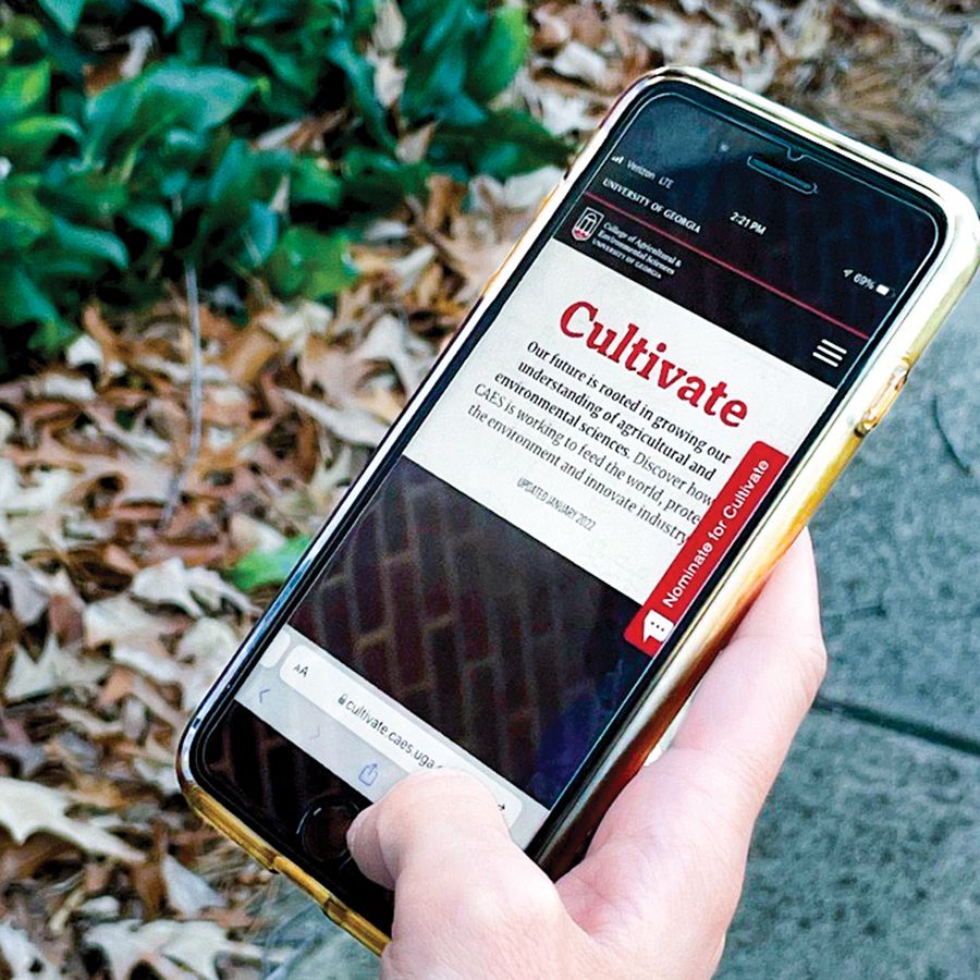 A hand holding a smartphone with a preview of Cultivate on it.