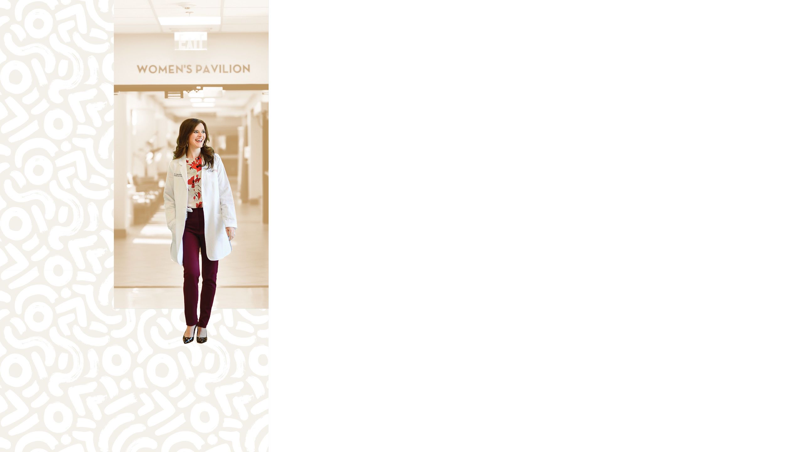 Ashlee Nicole Tillery walks down a hallway in a white lab coat, smiling at something off camera.