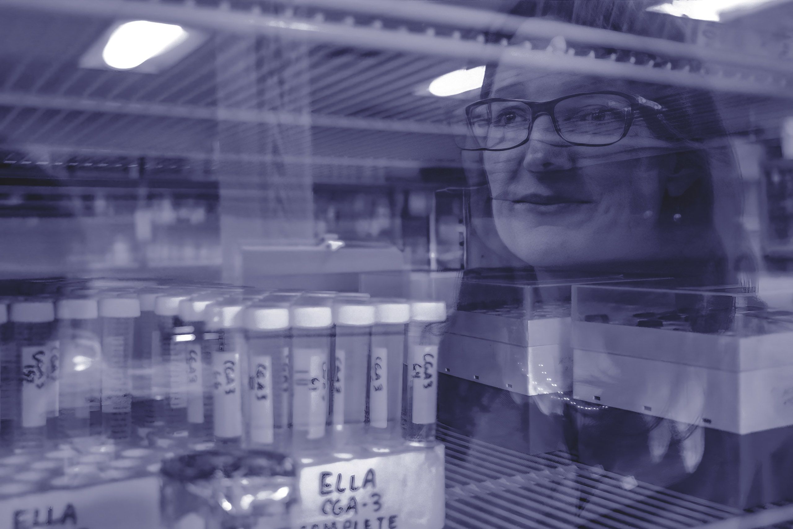 Monochrome portrait photo Marin Brewer overlaid over a glass door in a lab containing samples