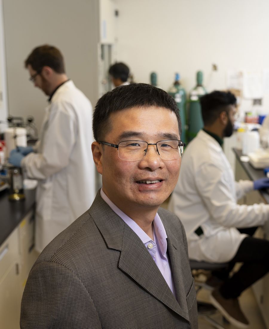 A portrait of Professor Qingguo (Jack) Huang in a laboratory setting.